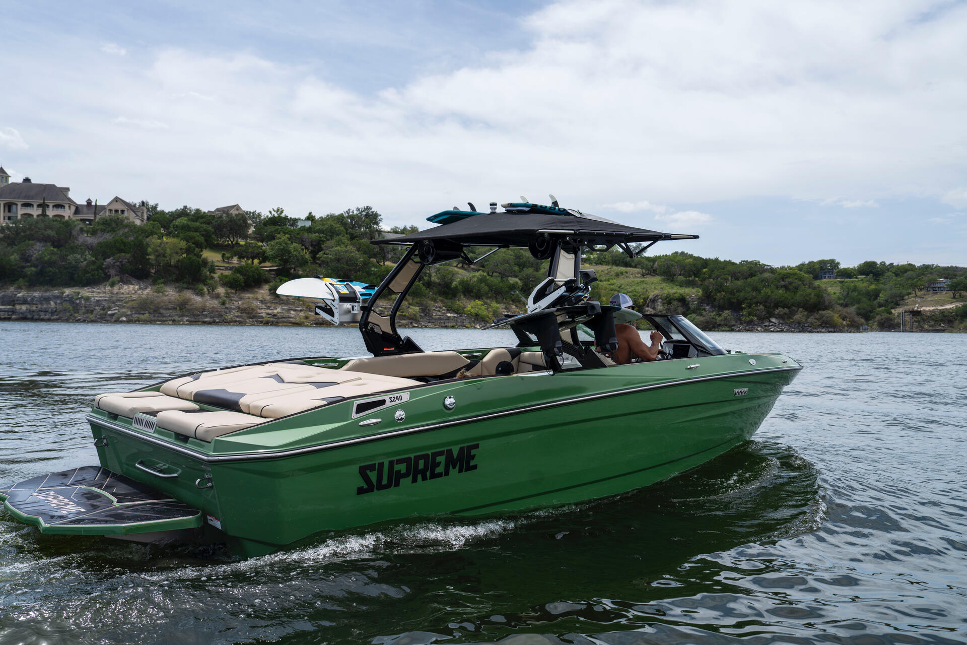 Supreme wake boat from behind on Lake Travis